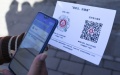 Scans a QR code in China. Photo by Xinhua/Ju Huanzong.