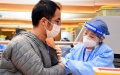 A man receives a shot of Covid-19 vaccine in Beijing. Photo by Xinhua/Ren Chao.