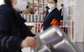 A staff member supervises the "Clean Your Plate" campaign among staff at a canteen of a central government institution in Beijing. Photo by Xinhua/Liu Bin.