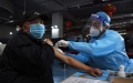 A resident is inoculated at a vaccination site in Beijing, China. Photo by  Xinhua/Ren Chao.