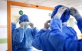 A medical worker wears protective equipment before entering the isolation ward at Wuhan, central China's Hubei Province. Photo by Xinhua/Xiao Yijiu.