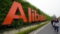 Staff members walking past the logo of Alibaba at Alibaba Group's Xixi base in Hangzhou, capital of east China's Zhejiang Province. Photo by Xinhua/Ju Huanzong.