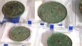 Chinese archaeologists have unearthed 2,000-yr-old glossy bronze mirrors. Photo by Xinhua.