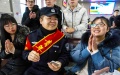 A policeman introduces telecom fraud countermeasures to passengers at the Shihezi Railway Station, northwest China's Xinjiang Uygur Autonomous Region.  Photo by Xinhua/Zhao Ge.