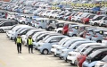 Workers check new energy vehicles at a logistics park in Liuzhou, south China's Guangxi Zhuang Autonomous Region. Photo by Li Hanchi/Xinhua.