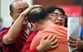 Mao Yin hugs his parents after being abducted as a toddler 32 years ago in Xi'an, northwest China's Shaanxi Province. Photo by Xinhua/Zhang Bowen.