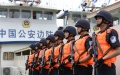 Members of Yunnan border police bureau line up as their patrol missions along the Mekong River. Photo by Xinhua.

