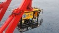 Researchers of the Chinese scientific research vessel Kexue, or Science, deploy an unmanned submersible in a certain area of the sea. Photo by The Institute of Oceanology, Chinese Academy of Sciences/Handout via Xinhua.