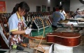 Workers assemble guitars at Zheng'an's international guitar industrial park. Photo by Xinhua/ Zhao Yandi.