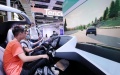 Visitors try automatic driving at theWorld Artificial Intelligence Conference (WAIC) in east China's Shanghai. Photo by Xinhua/Fang Zhe.