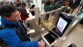 Passengers were using the self-service check-in equipment at Shanghai Hongqiao International Airport. Photo by Xinhua/Chen Fei.
