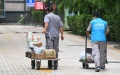 Volunteers deliver necessities ordered by residents under home quarantine at a community in Haidian District, Beijing, capital of China. Photo by Xinhua/Ren Chao.