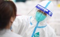 A medical worker takes a swab sample from a woman at a COVID-19 nucleic acid testing site in Jiangning District of Nanjing, capital city of east China's Jiangsu Province. Photo by Xinhua/Ji Chunpeng.