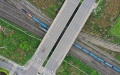 Aerial photo shows a Yuxinou (Chongqing-Xinjiang-Europe) China-Europe freight train running beneath a bridge in southwest China's Chongqing Municipality. Photo by Xinhua/Tang Yi.