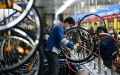 Workers assemble bicycle parts at a factory in Wuqing district of north China's Tianjin. Photo by Sun Fanyue/Xinhua.