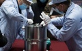 Scientific researchers transfer the container loaded with moon samples retrieved by the Chang'e-5 probe. Photo by Xinhua/Jin Liwang.