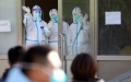 Medical workers wave to the cured patients discharged from the isolation ward in Dalian, northeast China's Liaoning Province. Photo by Xinhua/Yao Jianfeng.