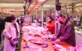 Residents buy pork at a wholesale market in Hohhot, north China's Inner Mongolia Autonomous Region. Photo by Xinhua/Peng Yuan.