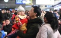 A man holding a child waits for a train at Beijing West Railway Station in Beijing, capital of China. Photo by Xinhua/Ren Chao.