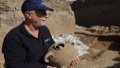Archaeologist of Israel Antiquities Authority shows a pottery at an excavation site in the central Israeli city of Yavne. Photo by Gil Cohen Magen/Xinhua.
