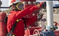 A Sinopec employee collects an oil sample at the Shunbei oil and gas field in the Xinjiang Uygur autonomous region. Photo by Xinhua.
