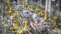 Intelligent robots weld bodies of cars at a new energy vehicle company in Chongqing, southwest China. Photo by Xinhua/Huang Wei.
