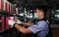 A customs official seizing smuggled cosmetics. Photo by Shenzhen Customs/Handout via Xinhua.