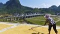 A farmer airs reaped grain in Puan Township, Sandu County in southwest China's Guizhou Province. Photo by Xinhua/Lu Dehua.