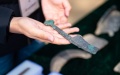An archaeologist displays an unearthed relic at the Liulihe relic site in southwest Beijing. Photo by Xinhua/Chen Zhonghao.