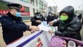 Police officers distribute anti-drug publicity leaflets to locals in Xinhe County, north China's Hebei Province. Photo by Xinhua/Wang Xiao.