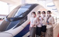 Staff members pose for photos beside the Lane Xang EMU train of the China-Laos Railway at the Vientiane railway station in Vientiane, capital of Laos. Photo by Kaikeo Saiyasane/Xinhua.