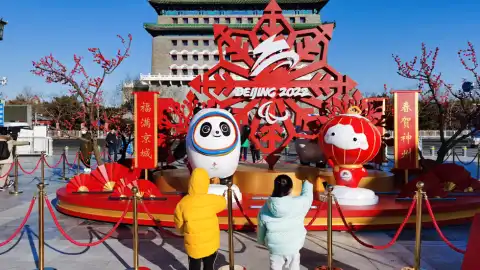 Several children looking at street decorations for the Beijing 2022 Olympic and Paralympic Winter Games before the upcoming Chinese Lunar New Year in Beijing. Photo by Xinhua.
