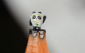 A Chinese artist carves miniature sculptures out of pencil lead. Photo by Xinhua.