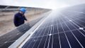 A worker checks the solar cell modules in a photovoltaic industrial park in Qinghai Province, northwest China. Photo by Xinhua/Wu Gang.