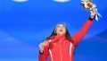 Gold medalist Gu Ailing of China reacts during the awarding ceremony of women's freeski big air at the Beijing Medals Plaza of the Winter Olympics in Beijing with a Woolen bouquet. Photo by Xinhua/Huang Zongzhi.