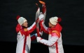 Torch bearer Yang Yang (L) hands over the flame to the torch bearer Su Bingtian during the opening ceremony of the Beijing 2022 Olympic Winter Games at the National Stadium in the capital of China. Photo by Xinhua/Xue Yuge.
