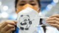Han Zhebin, a volunteer of the Beijing 2022 Winter Olympics, shows a hand-painted mask she made at National Biathlon Centre in Zhangjiakou, North China's Hebei Province.  Photo by Xinhua/Ding Ting.