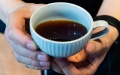 A barista presents a cup of coffee at an African coffee shop in Changsha, central China's Hunan Province. Photo by Xinhua/Chen Sihan.