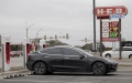 A Tesla electric car charges as gas prices are advertised in San Antonio, Texas, the United States. Photo by Nick Wagner/Xinhua.