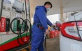 A member of staff refills the tank of a car at a gas station in Lianyungang City, east China's Jiangsu Province. Photo by Wang Jianmin/Xinhua.