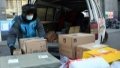 A courier arranges parcels to be delivered to residents at a residential compound in Haidian District of Beijing. Photo by Xinhua/Ren Chao.