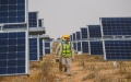 Staff members check equipment of the Dalad Photovoltaic Power Base in Dalad Banner, north China's Inner Mongolia Autonomous Region. Photo by Xinhua/Liu Lei.
