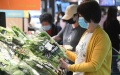 Citizens select vegetables at a supermarket in Haidian District, Beijing, capital of China. Photo by Xinhua/Ren Chao.
