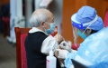 A medical worker injects COVID-19 vaccine for a senior citizen in Dongcheng District of Beijing. Photo by Xinhua/Ju Huanzong.