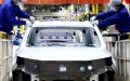 Workers work at the assembly workshop of automaker SAIC Motor Company's Lingang base in Shanghai, east China. Photo by Xinhua/Chen Jianli.