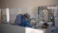 A medical worker treats a COVID-19 patient at a hospital in Barcelona, Spain. Photo by Francisco Avia/Xinhua.