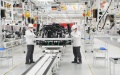 People work at the assembly line of China's leading automaker FAW Group Co., Ltd. based in Changchun, capital of northeast China's Jilin Province. Photo by Xinhua.