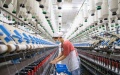 A worker operates on the production line at a textile company in Nanmo Township of Hai'an City, east China's Jiangsu Province. Photo by Zhai Huiyong/Xinhua.