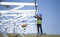 Staff members work at the construction site of a one million kilowatts photovoltaic project in Gonghe County of Hainan Tibetan Autonomous Prefecture, northwest China's Qinghai Province. Photo by Xinhua/Zhang Long.