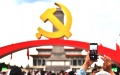 A man takes photos of the decoration set up for the ceremony marking the 100th anniversary of the founding of the Communist party of China at Tian'anmen Square in Beijing. Photo by Xinhua/Li Xin.